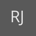 Rebecca Jacobs avatar consisting of their initials in a circle with a dark grey background and light grey text.
