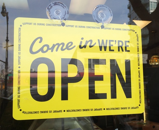 To address falling revenues caused by ongoing plaza construction, the Myrtle Avenue Brooklyn Partnership launched a marketing campaign that included putting these signs in storefront. Photo: Myrtle Avenue Brooklyn Partnership
