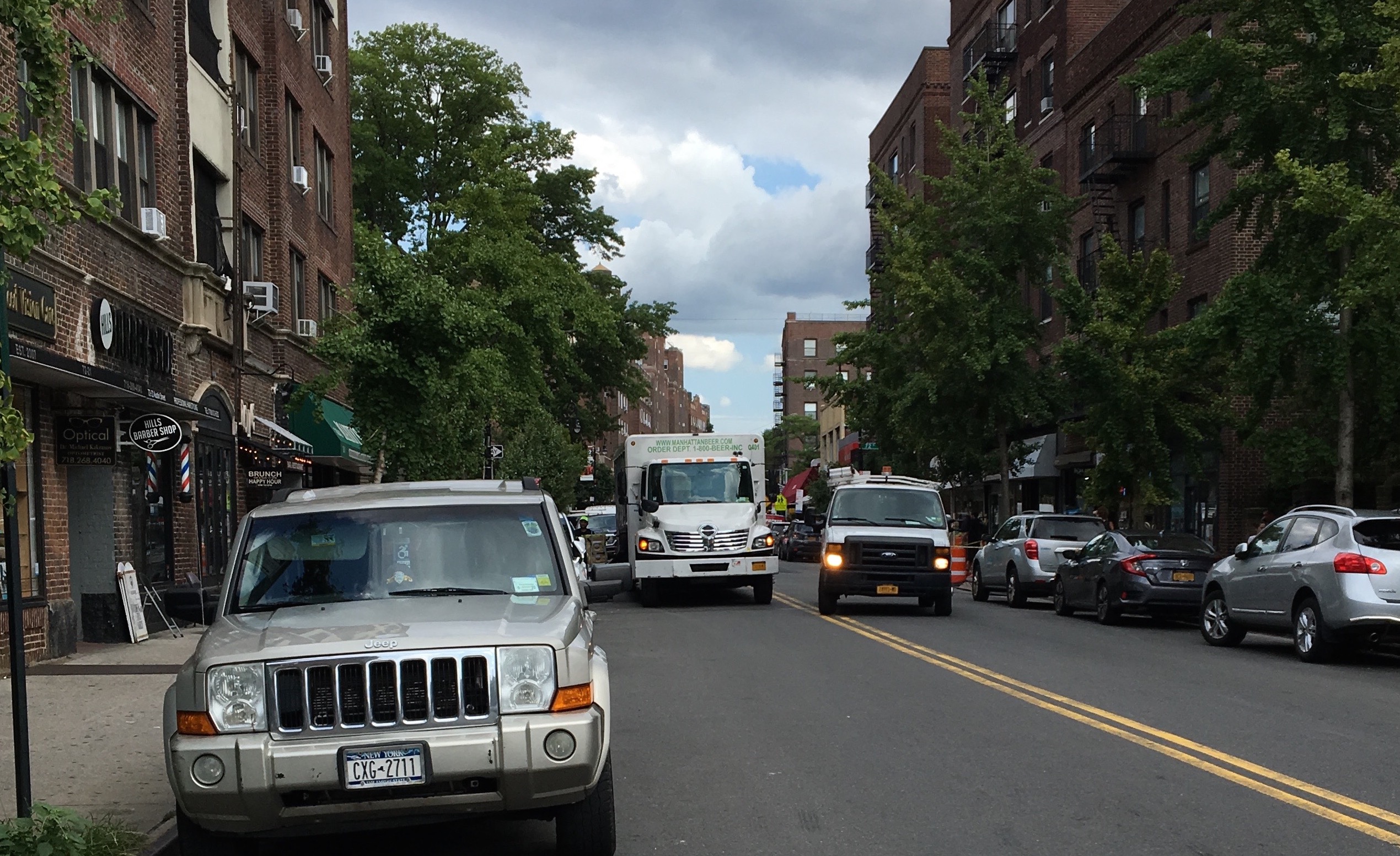 This is what double-parking causes — cars driving down the wrong side of the road. Photo: Laura A. Shepard.