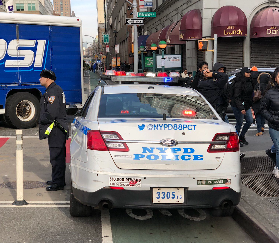 Yesterday, officers from the 88th Precinct parked in this exact location forced a cyclist into traffic, where she was injured. Today, the precinct was back in the same location. Photo: Ian Dutton
