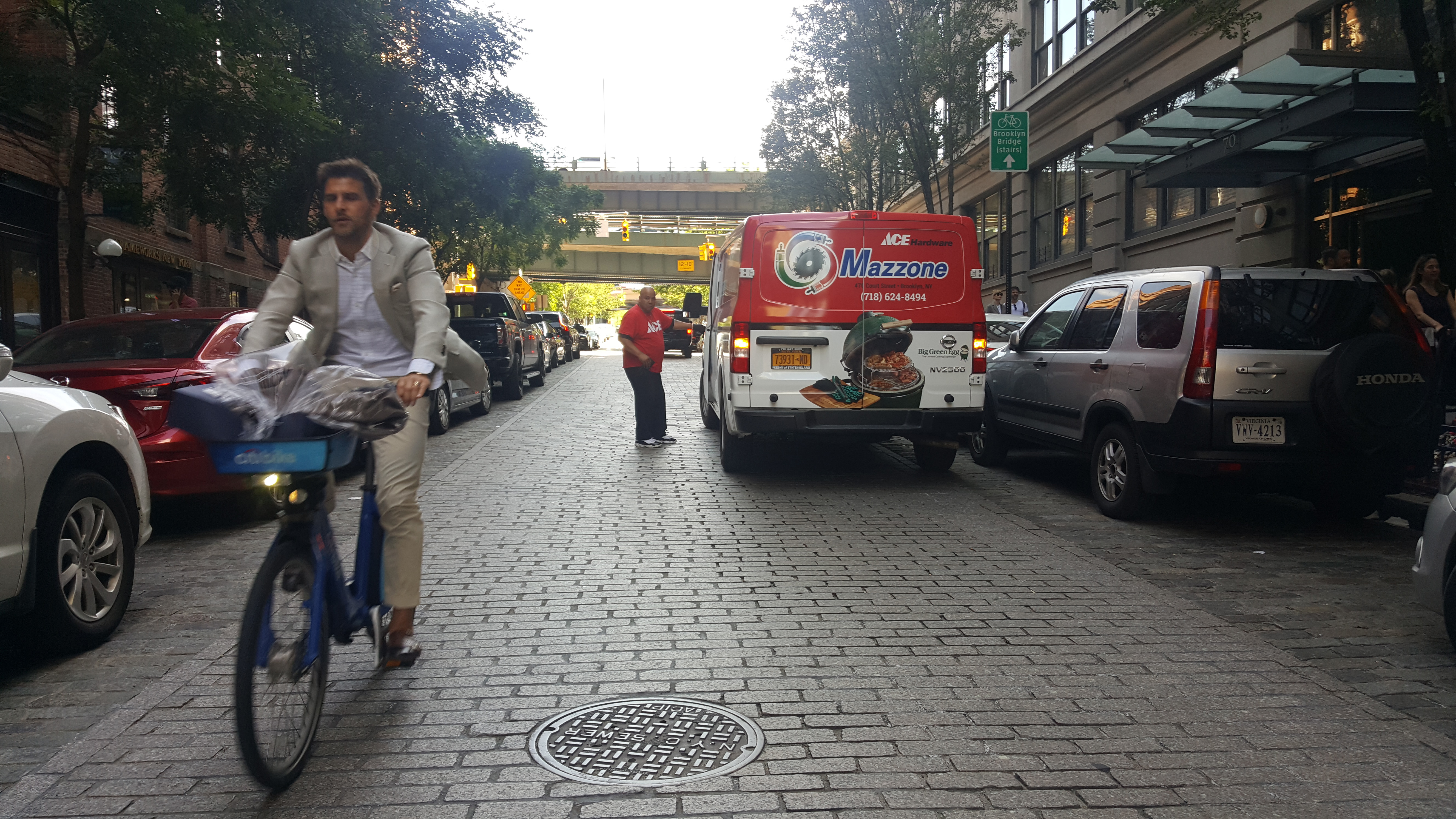 A cyclist heading the wrong way down the newly one-way Washington Street in DUMBO. The double-parked truck is a key source of the problem. Photo: Daniel Hopkins