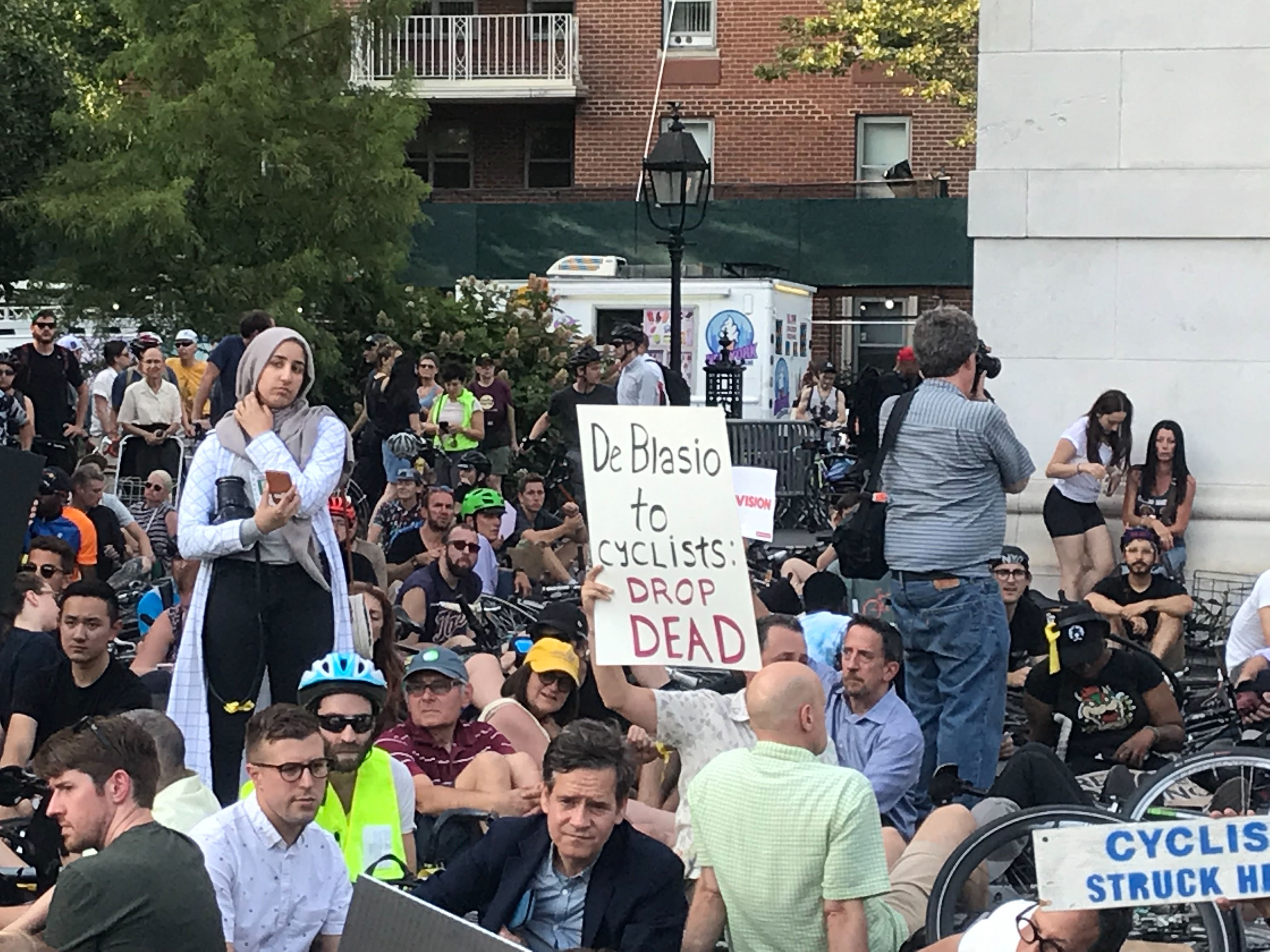 A protester holds a sign venting at Mayor de Blasio for his lack of attention to Vision Zero.