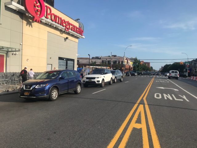 Cars double park with impunity on the block. Photo by Dave Colon