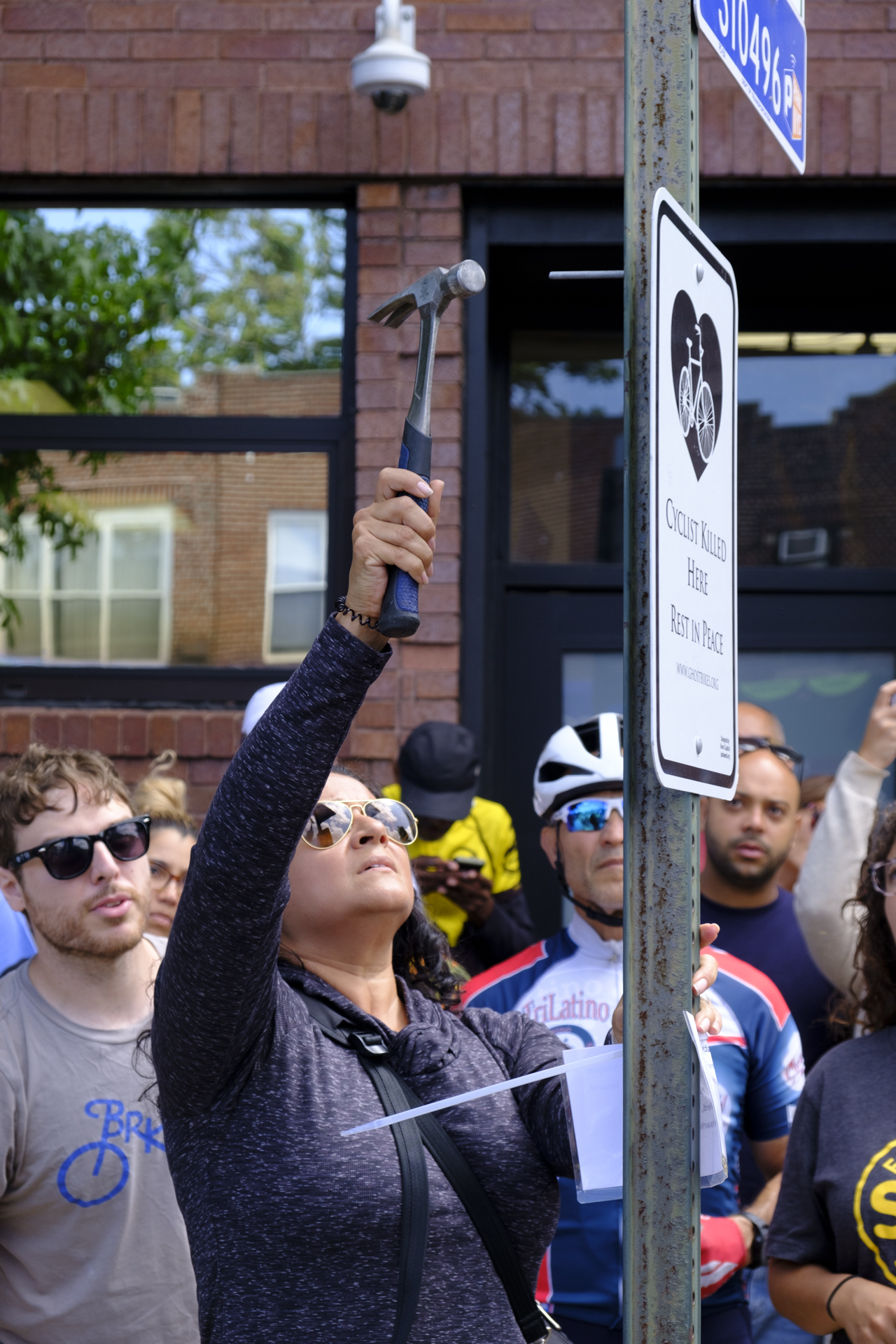 Alzorriz's partner Irene Hanna helped hang the ghost bike sign. Photo: Vladimir Vince