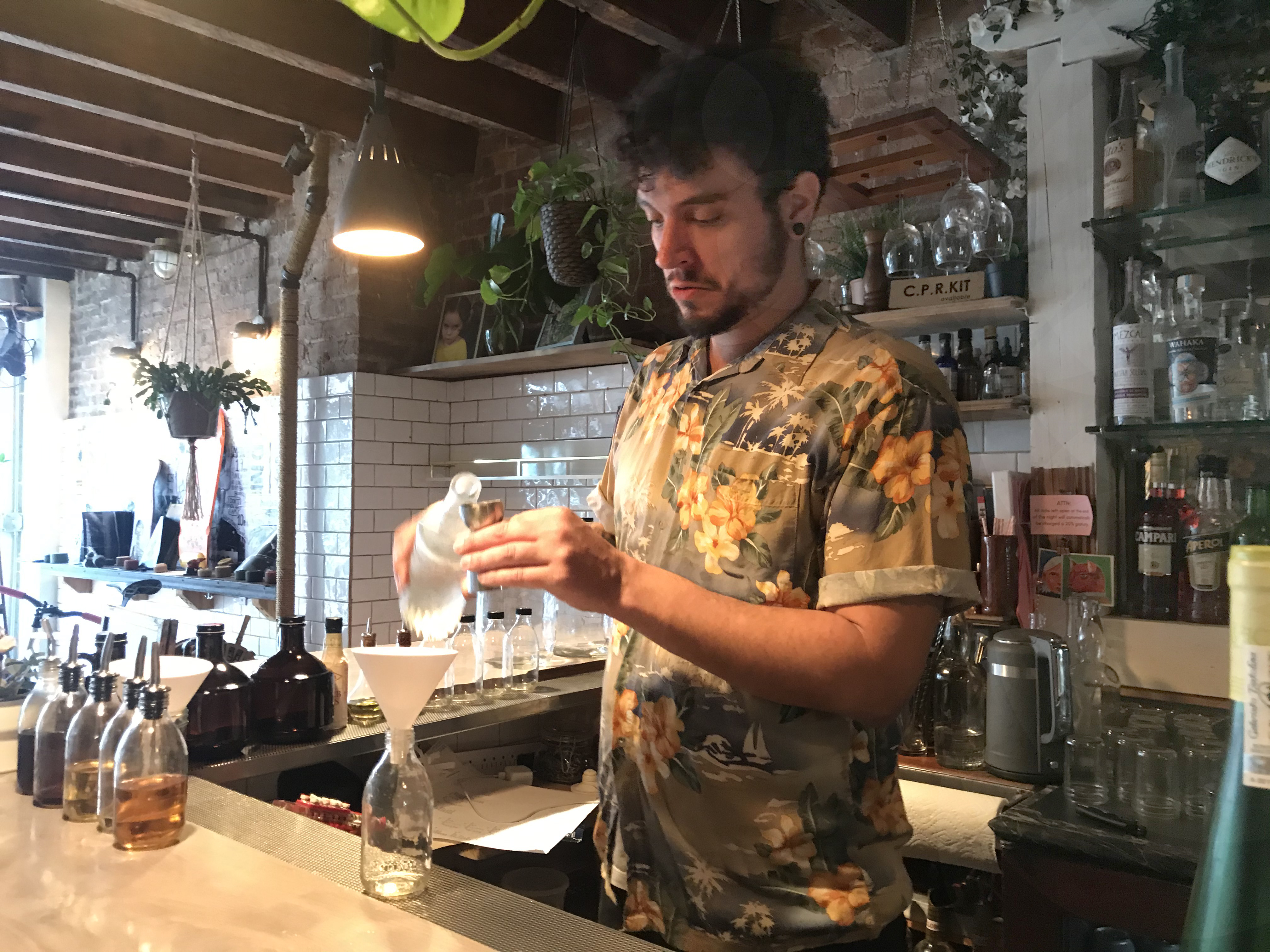 Roughton mixes up a Staycation, a custom cocktail of his own making, for delivery. Photo: Dave Colon