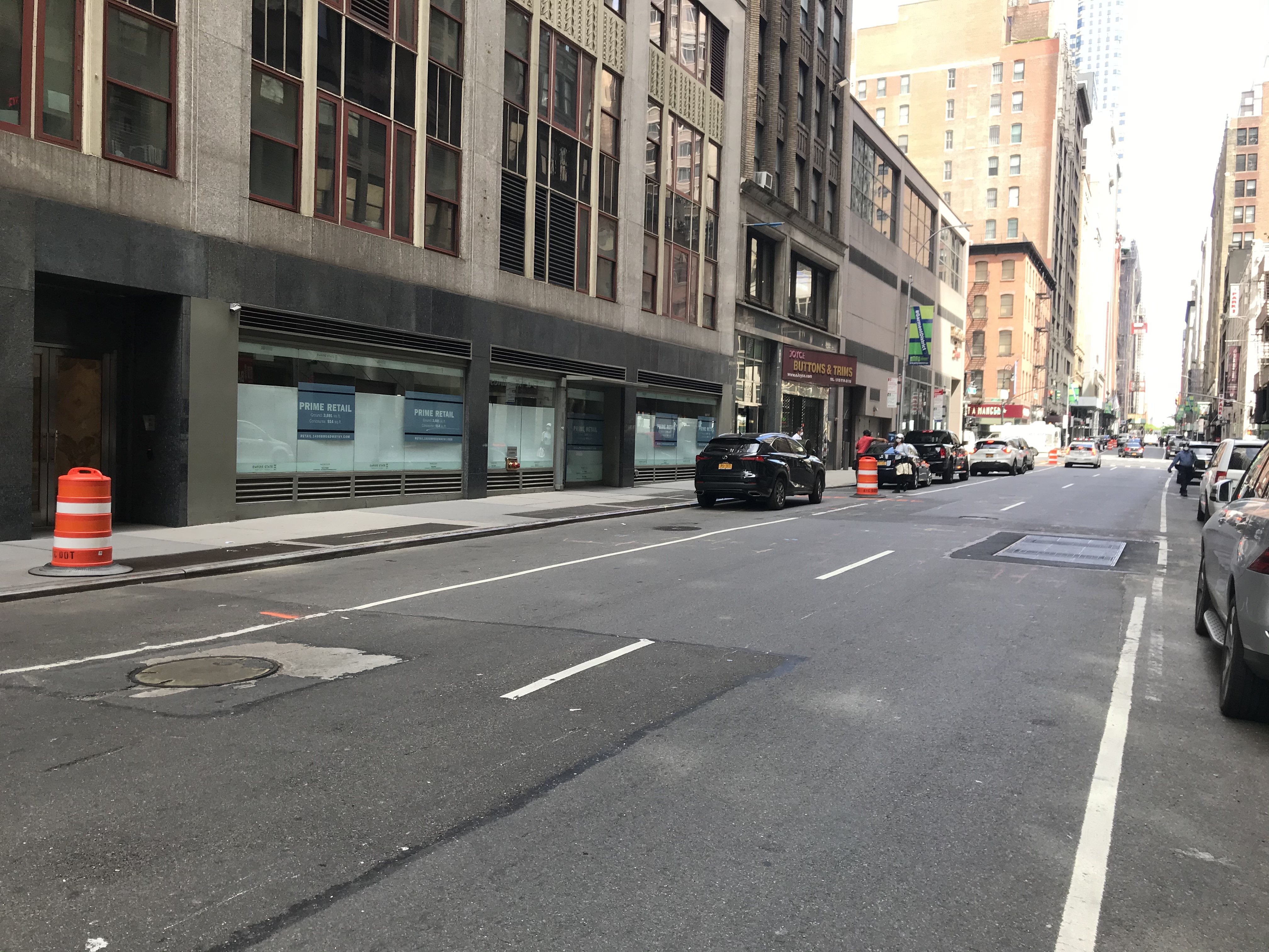38th Street between 6th Avenue and 7th Avenue. The police car on the side of the east end of the block was parked next to the barrel on the sidewalk. Photo: Dave Colon
