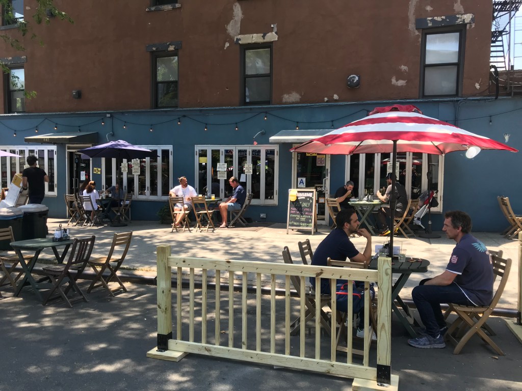 Improv at the Curbside: Outdoor Dining Program Kicks Off With Varied Security Barriers