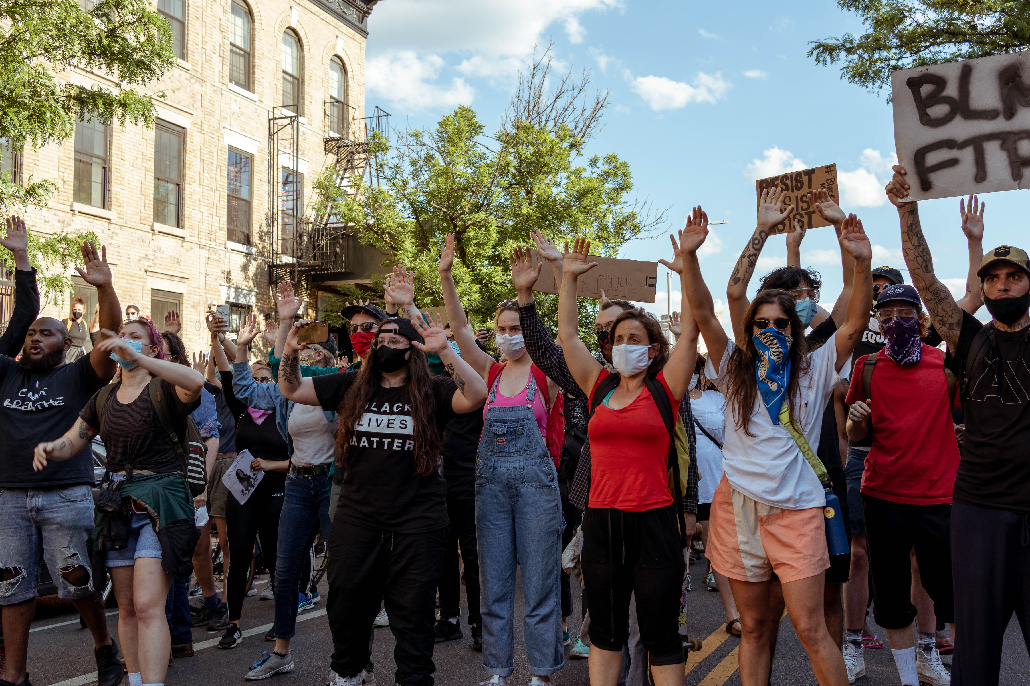 Marchers moved forward with their hands up to indicate non-violence. Photo: Kel Bush