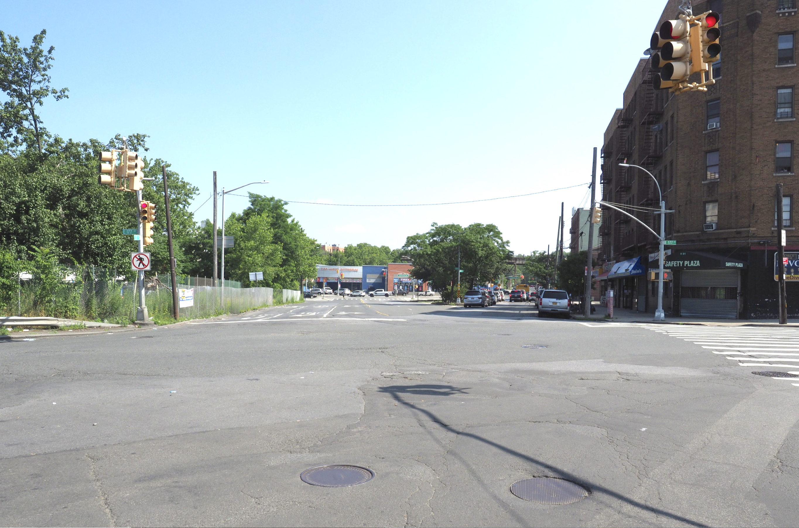Looking north from the East 177th Street entrance of Starlight Park. Pedestrians and cyclists face an off/on ramp to the Sheridan Blvd and Cross Bronx Expressway (seen left), an MTA bus depot entrance (not pictured to the right), and over five lanes of local traffic as Devoe Avenue and East 177th Street converge.
