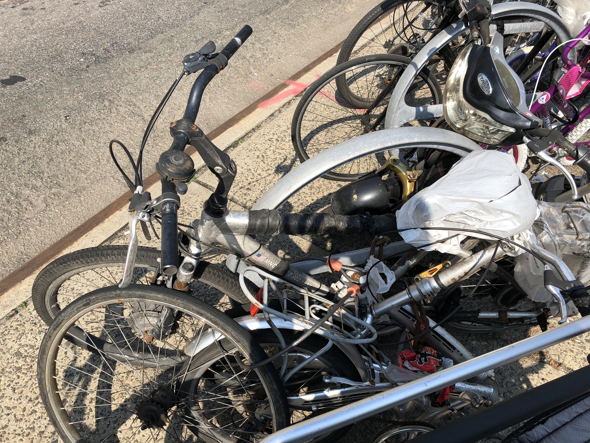 The scene in June, 2019 — after DSNY said it could not remove derelict bikes because they did not meet the criteria. Photo: Stephen Brown