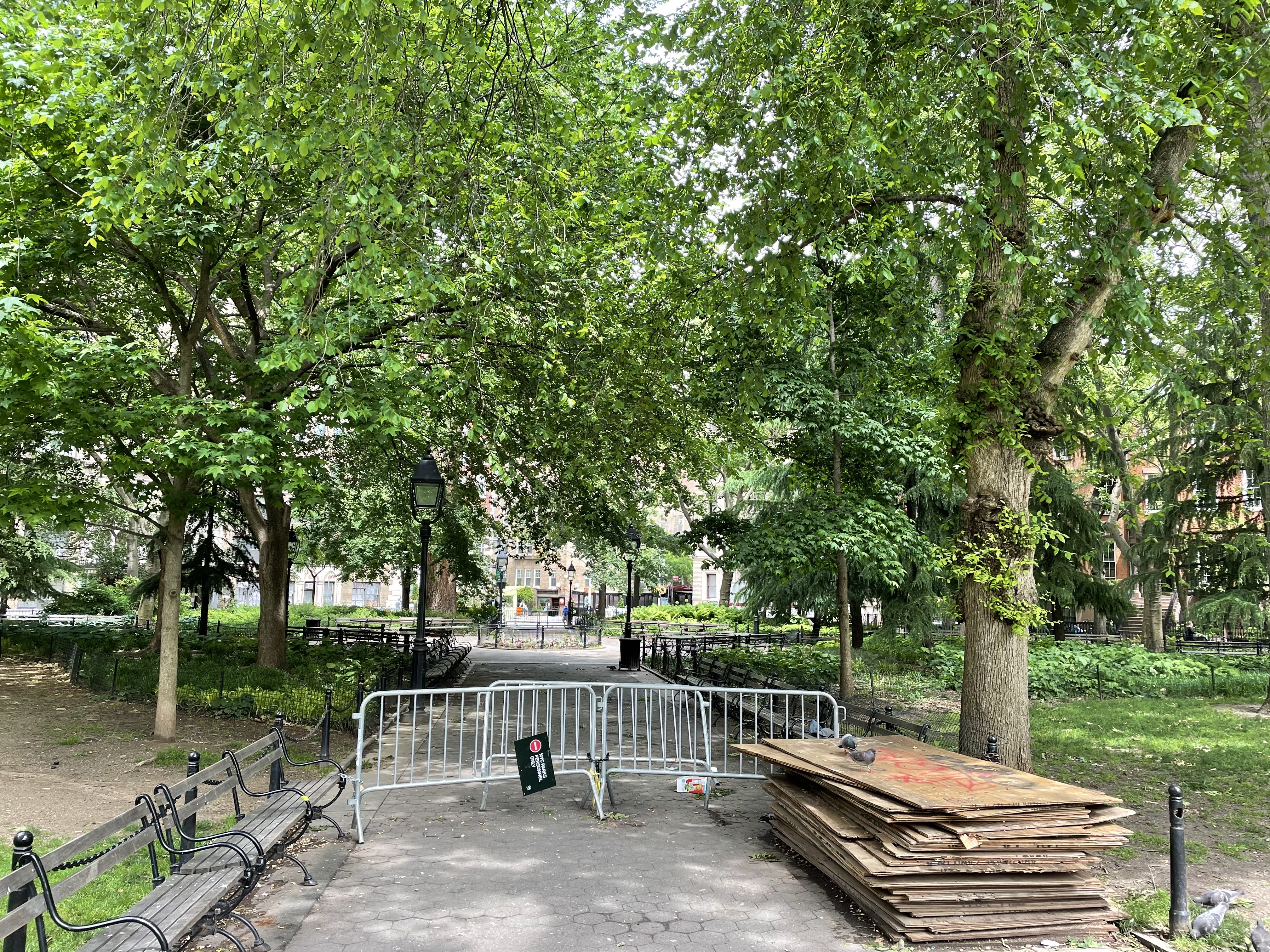 A metal barricade seals off the northwestern quadrant of Washington Square Park.