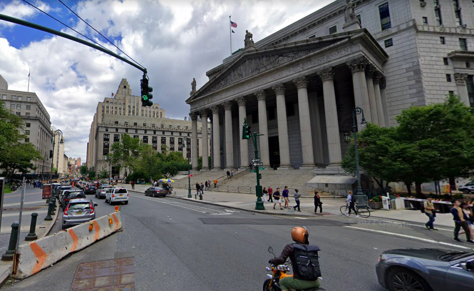 Here's what the area looked like in 2019. Not the unprotected bike lane at the right with a car in it, and note the motorcyclist in danger. Photo: Google