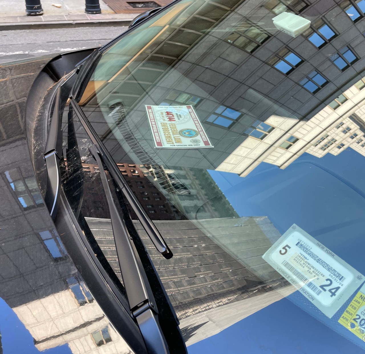 A car with a "Federal Law Enforcement" placard parked in the Reade Street bike lane. Photo: Dave Colon