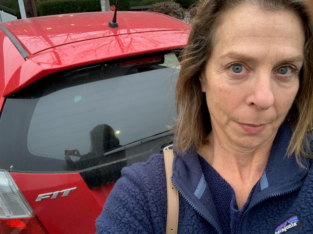 Stacy Sacks with her red Honda Fit. Note: This is NOT the speeding car in the picture from the Department of Finance.