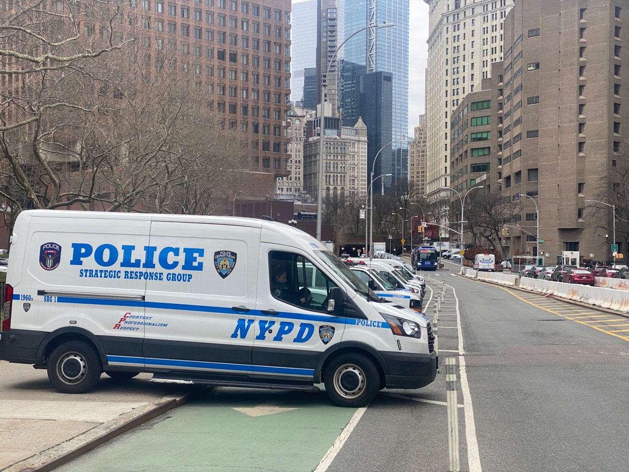 Combat-parked cop cars block the Park Row bike lane. Photo: Kevin Duggan