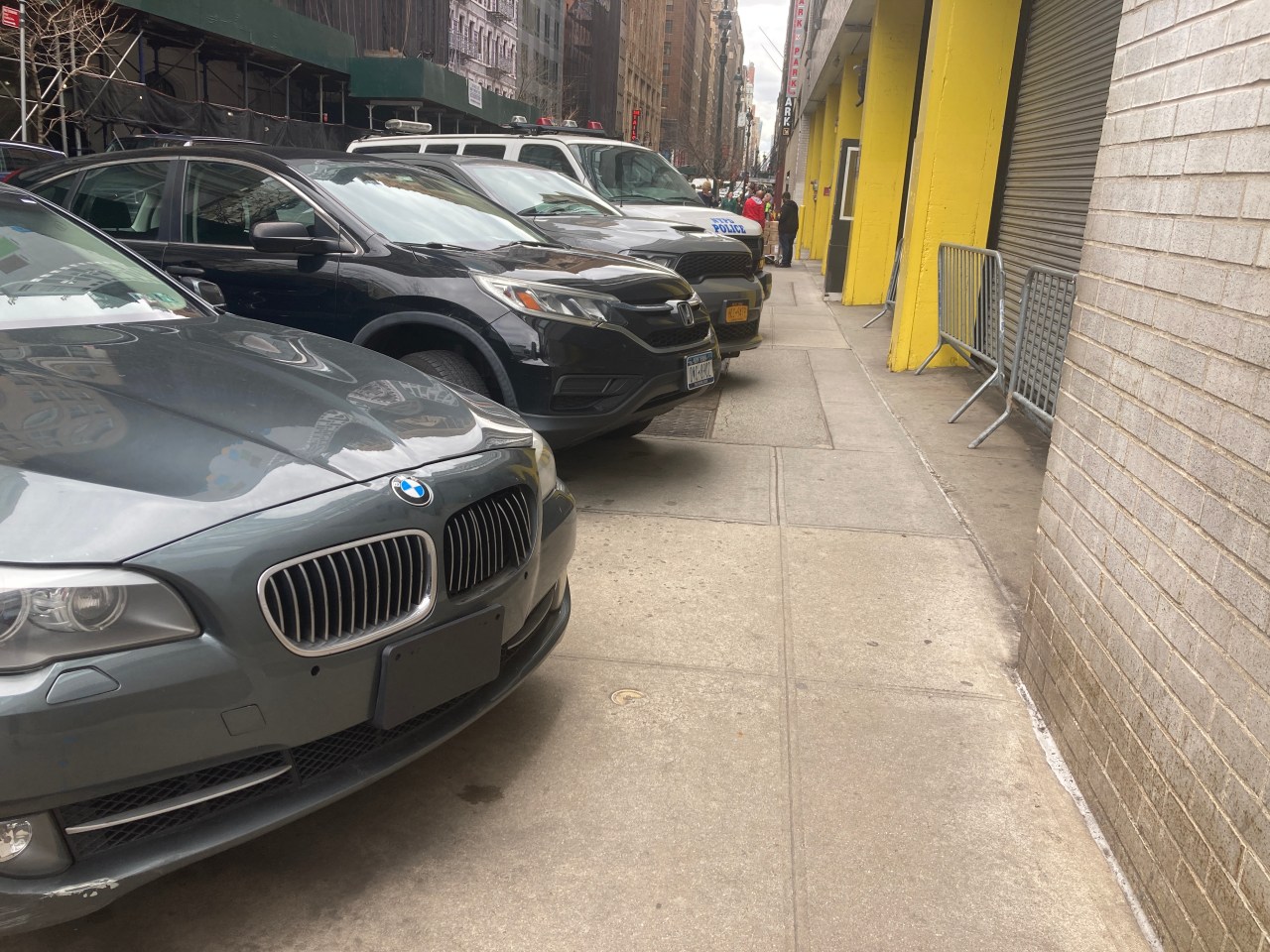 Cops from Midtown South Park on the sidewalk, forcing pedestrians to squeeze past.