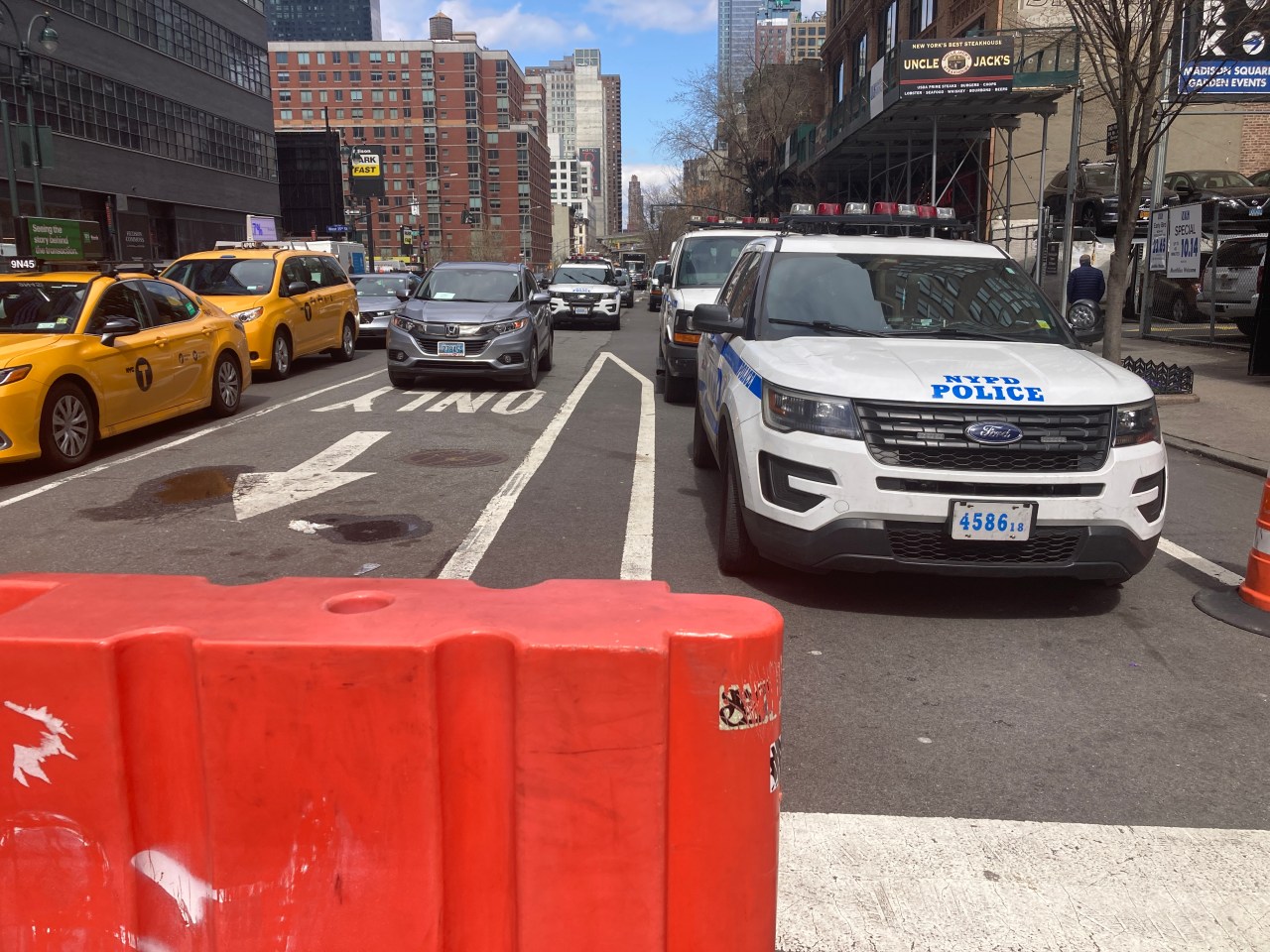 Cops from Midtown South precinct park in the middle of Ninth Avenue.