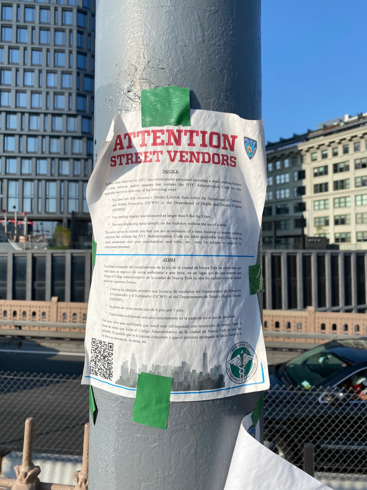 A notice to vendors posted on the bridge on May 11 telling vendors they violated city rules. Photo: Kevin Duggan