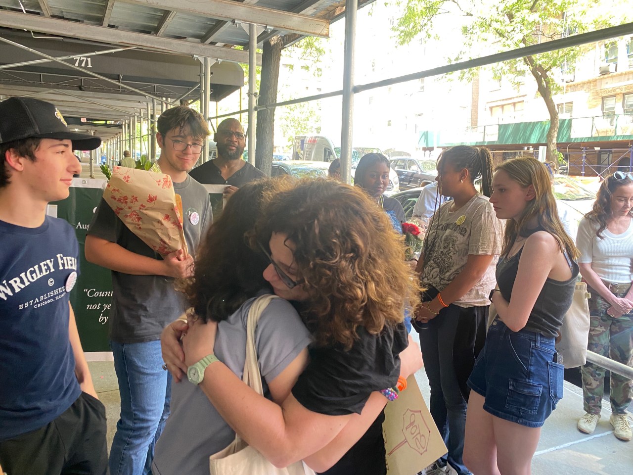 Dana Lerner (right) embraces Cooper's friends. Photo: Kevin Duggan
